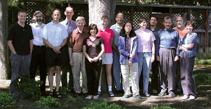 Fourteen people standing
in a park